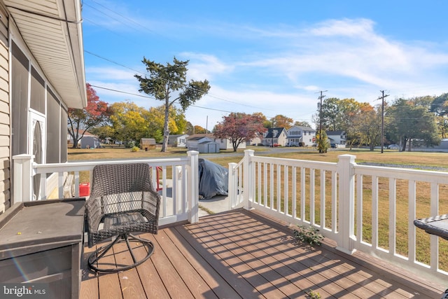 wooden deck featuring a yard