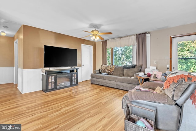 living room featuring light hardwood / wood-style flooring and ceiling fan