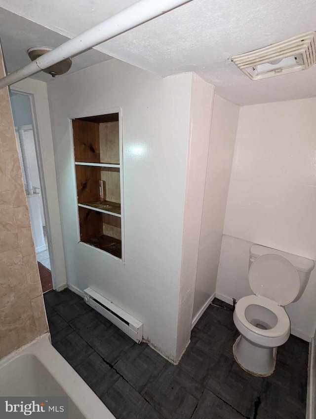 bathroom featuring toilet, a baseboard heating unit, and bathing tub / shower combination