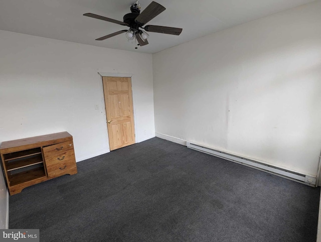 spare room with a baseboard heating unit, dark carpet, and ceiling fan