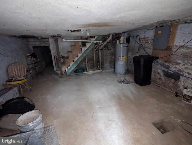 basement featuring electric panel and water heater