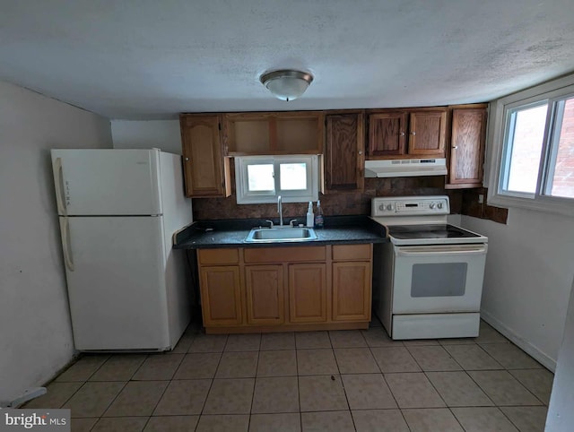 kitchen featuring a wealth of natural light, backsplash, sink, and white appliances