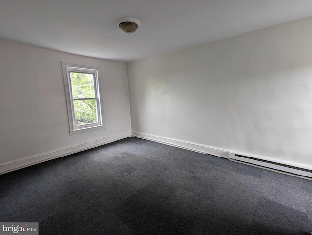 carpeted spare room with baseboard heating