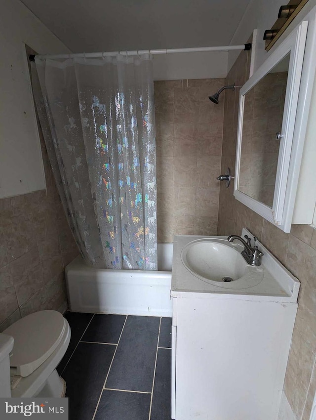 full bathroom featuring tile walls, toilet, shower / bath combo, vanity, and tile patterned flooring