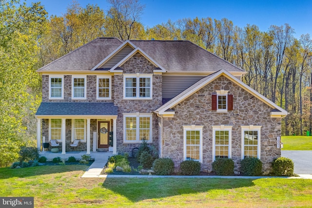 view of front facade with a front yard and covered porch