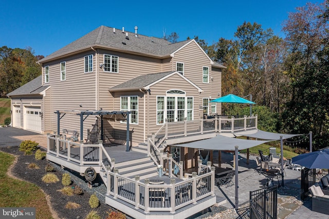 back of house featuring a wooden deck and a pergola