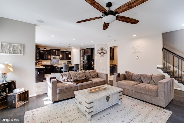 living room featuring ceiling fan and light hardwood / wood-style floors