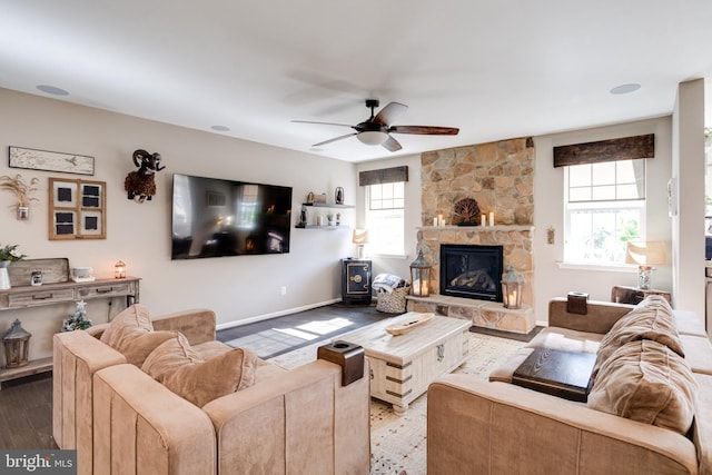 living room with hardwood / wood-style flooring, a fireplace, and ceiling fan