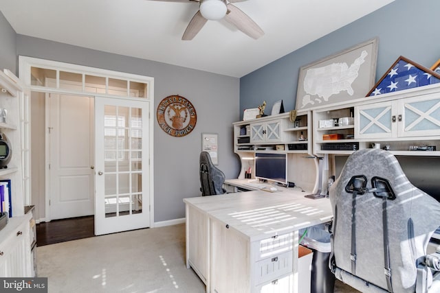 carpeted office with french doors and ceiling fan