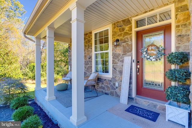 view of exterior entry featuring a porch