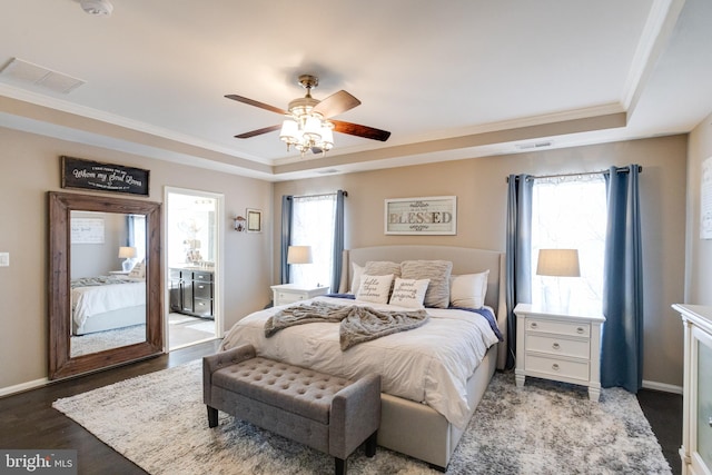 bedroom featuring crown molding, dark wood-type flooring, a raised ceiling, and ceiling fan