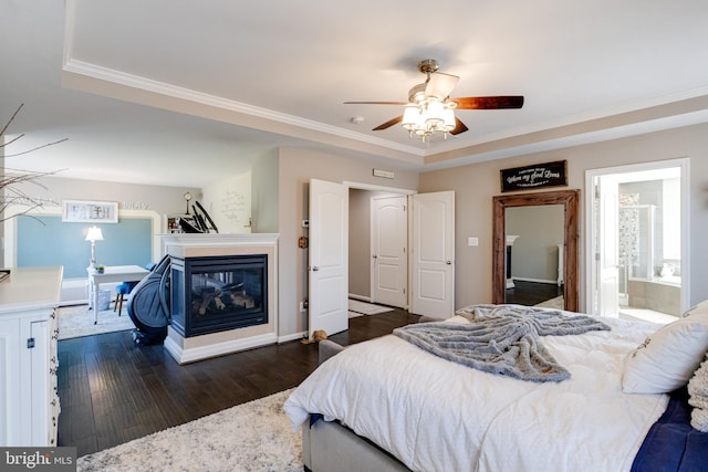 bedroom featuring crown molding, a multi sided fireplace, dark hardwood / wood-style floors, and ceiling fan