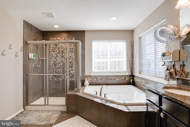 bathroom with vanity and plus walk in shower