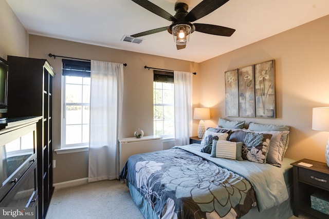 bedroom featuring light carpet and ceiling fan