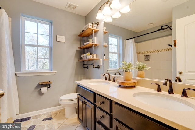 bathroom featuring tile patterned flooring, vanity, and toilet