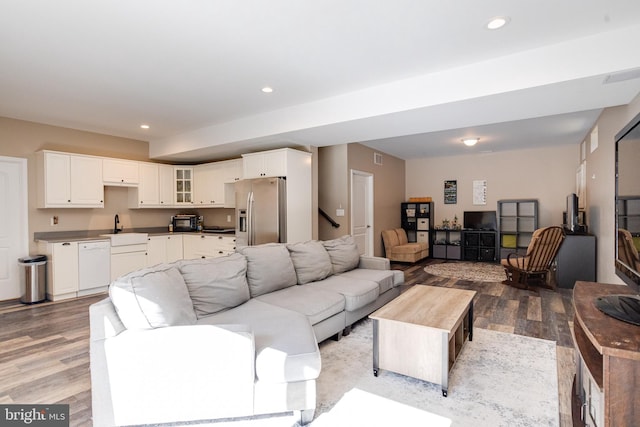 living room featuring sink and light wood-type flooring