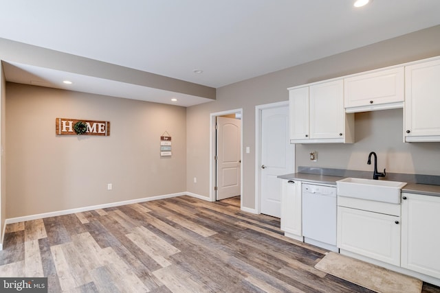 kitchen with white cabinetry, dishwasher, sink, and light wood-type flooring