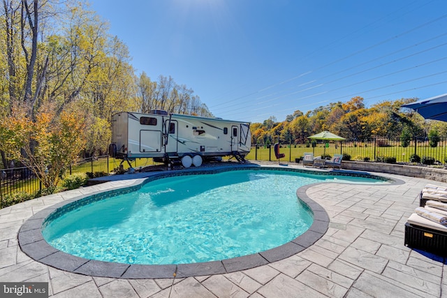 view of pool with an outdoor structure and a patio area