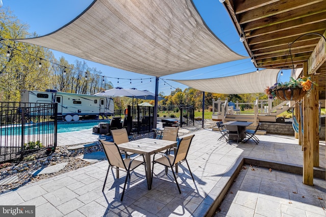 view of patio with a shed and a fenced in pool