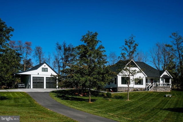 view of front of home with a carport, a garage, a front lawn, and a porch