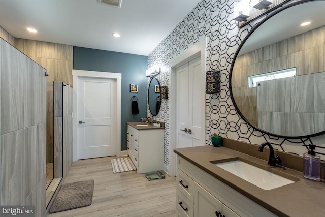 bathroom featuring vanity, hardwood / wood-style floors, and walk in shower