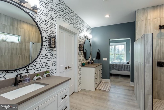 bathroom with vanity, a shower, and hardwood / wood-style flooring