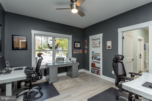 office with light hardwood / wood-style floors and ceiling fan