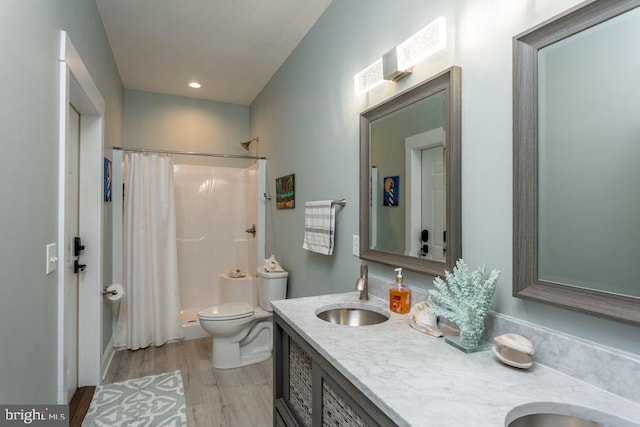 bathroom featuring vanity, toilet, a shower with curtain, and hardwood / wood-style floors