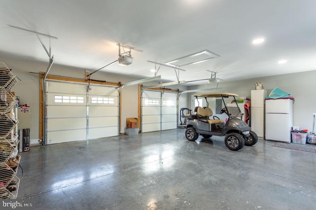 garage with a garage door opener and white refrigerator