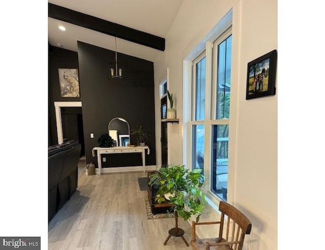 hall with vaulted ceiling with beams and hardwood / wood-style floors