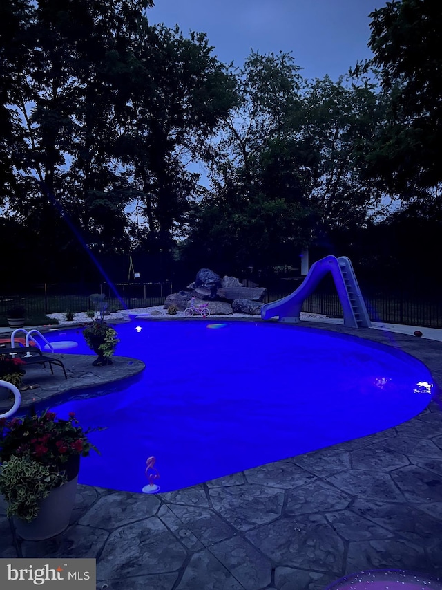 view of pool with a water slide