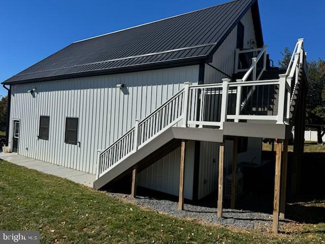 back of house with cooling unit and a deck