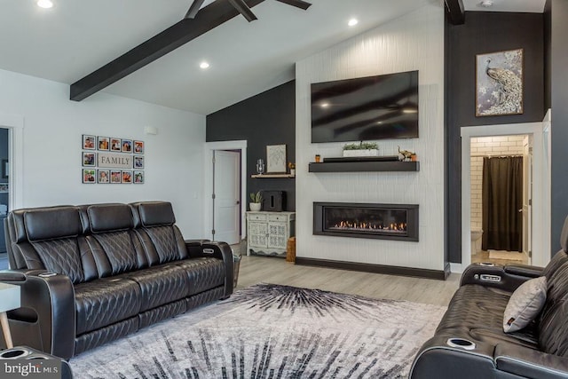 living room featuring beam ceiling, high vaulted ceiling, and light wood-type flooring