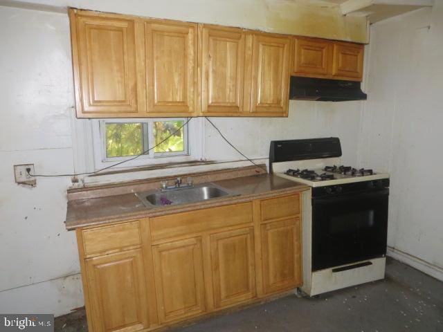 kitchen with white gas range and sink