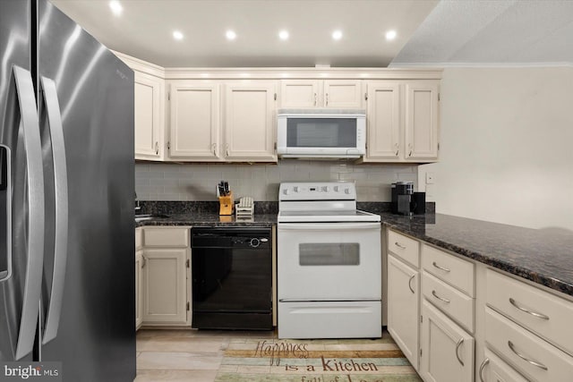 kitchen featuring appliances with stainless steel finishes, dark stone countertops, tasteful backsplash, and ornamental molding