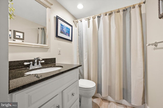 bathroom with vanity, toilet, and curtained shower