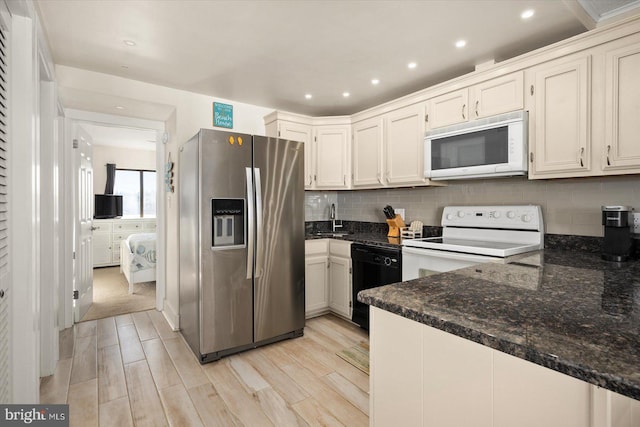 kitchen featuring light hardwood / wood-style flooring, decorative backsplash, sink, and white appliances