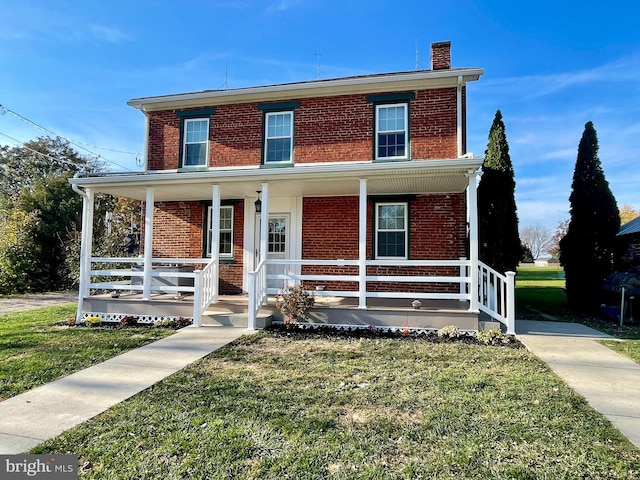 view of front of home with a porch and a front lawn