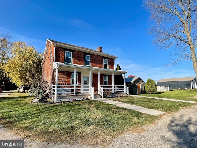 view of front of home featuring a front lawn and covered porch