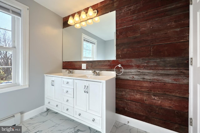 bathroom featuring a baseboard radiator, vanity, and a healthy amount of sunlight