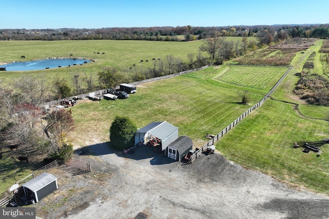 birds eye view of property with a water view and a rural view