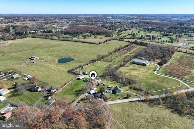 birds eye view of property with a rural view