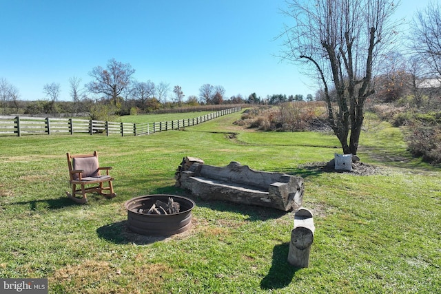 view of yard featuring a rural view and an outdoor fire pit