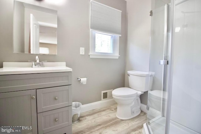 144 Sams Rd, Jackson, NJ 08527 - bathroom with toilet, wood finished floors, visible vents, a shower stall, and baseboards