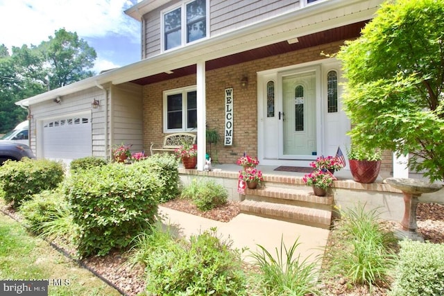 entrance to property featuring a porch and a garage