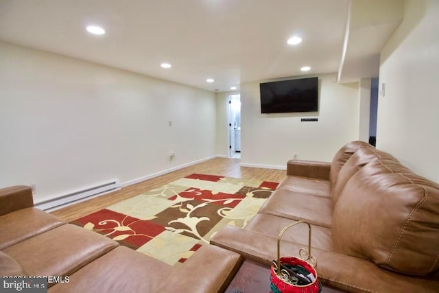 living room with baseboard heating and wood-type flooring