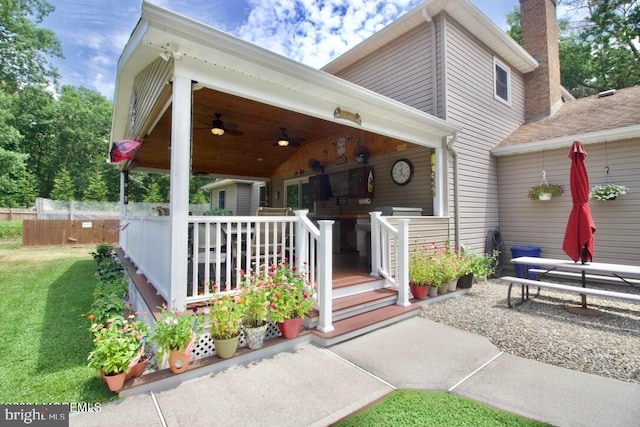 exterior space featuring a yard and ceiling fan