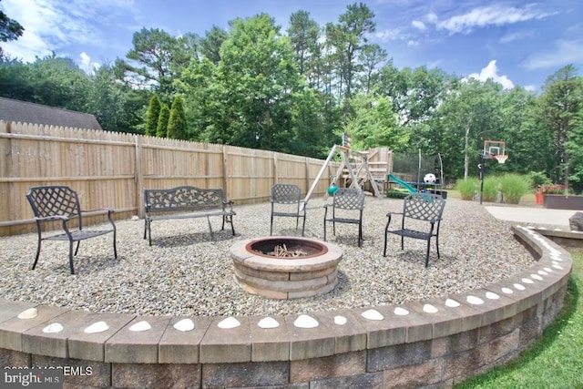 view of patio / terrace with a fire pit and a playground