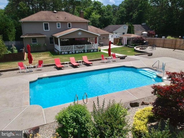 view of pool featuring a patio, an outbuilding, and a yard