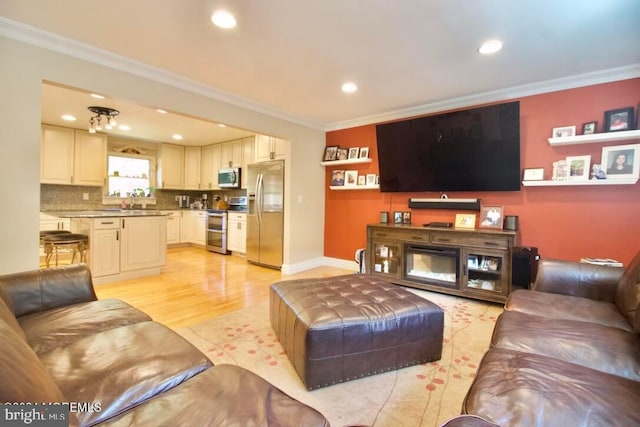 living room with ornamental molding and light wood-type flooring